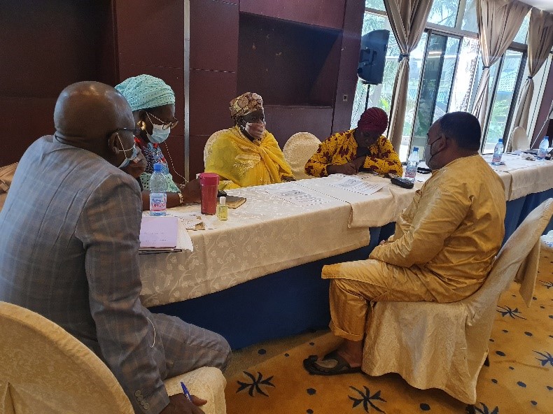 A group of people sitting around a table

Description automatically generated with medium confidence