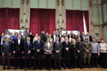 National, regional, and international representatives from various fields gather for a group photo.