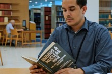 UN-Library-one-of-the-librarians-consulting-a-book-on-Nuclear-War-