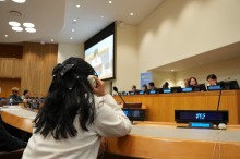 Young girl listening to a panel discussion at the 11th NPT Review Conference.